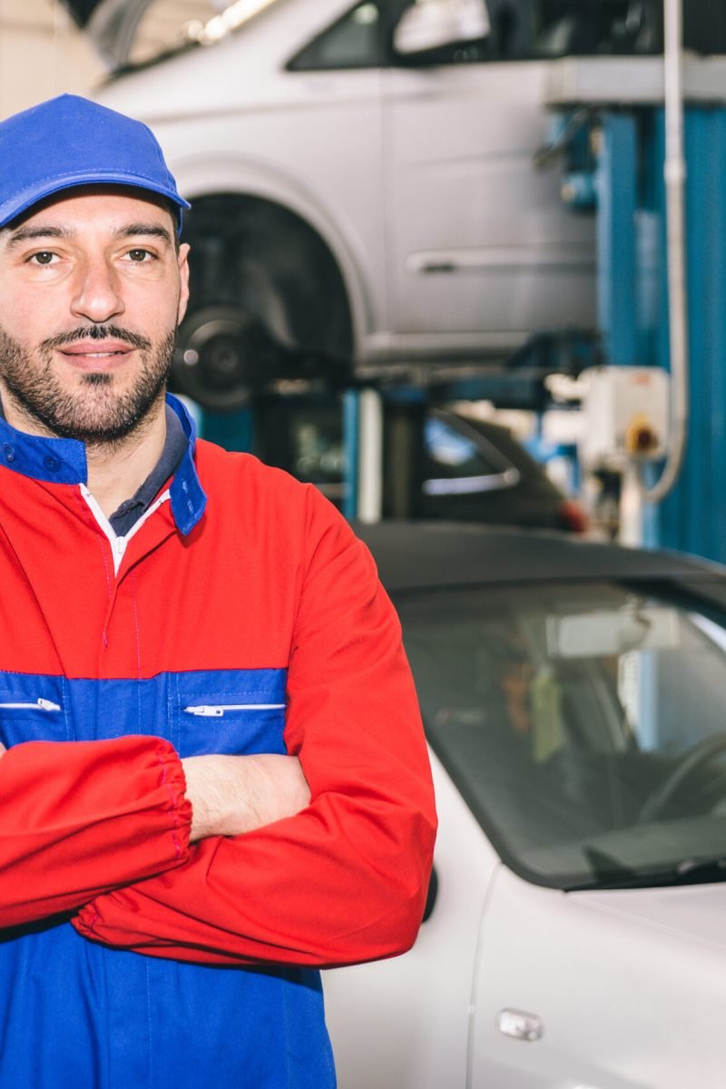 Mechanic portrait while working on a car. industrial concept about transportation
